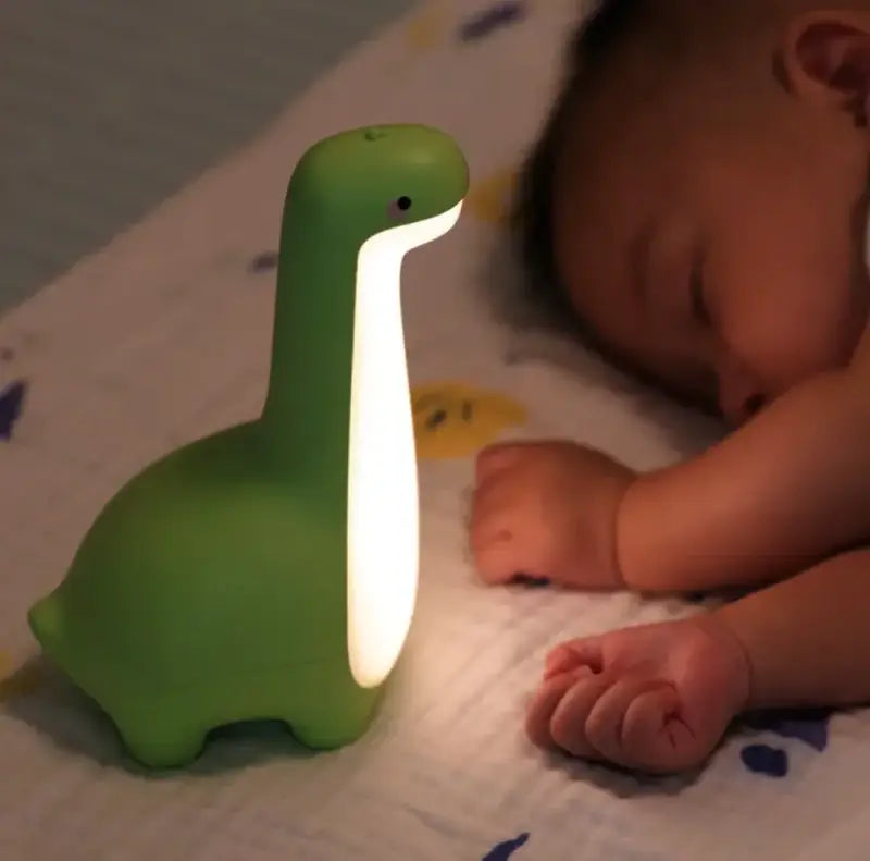 Luz nocturna de dinosaurio verde.