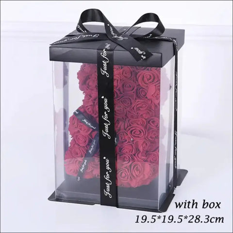 Rosas rojas en caja transparente con cinta negra, ideal para San Valentín y peluche artificial