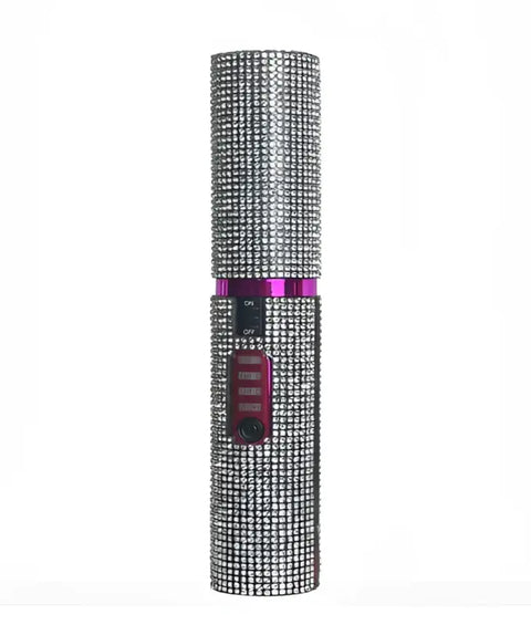 Imagen de un arma de autodefensa cubierta de rhinestones con banda púrpura para tu cabello