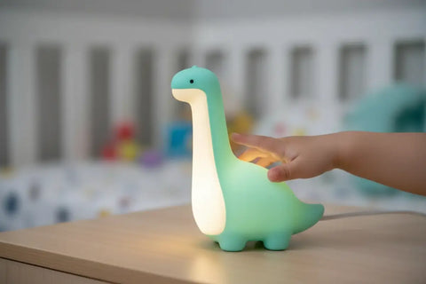 Luz nocturna dinosaurio de silicona teal y blanco con vientre luminoso