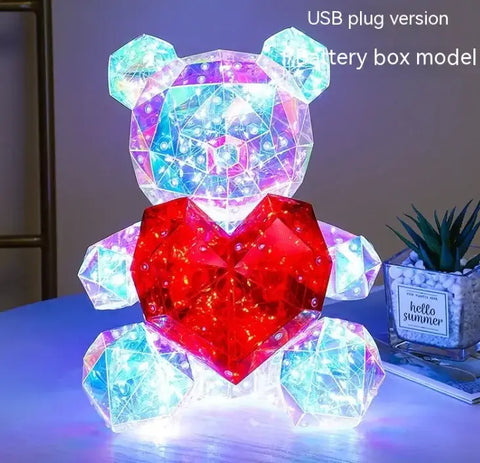 Ilustración de un oso de iluminación electrónica con corazón rojo en el producto Color Spark Luminous Bear