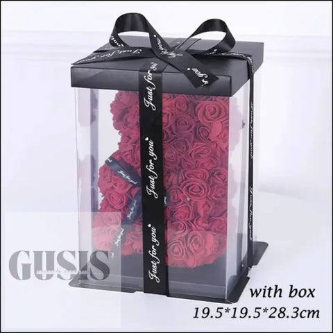 Rosas rojas en caja transparente con cinta negra, ideal para San Valentín y peluche artificial